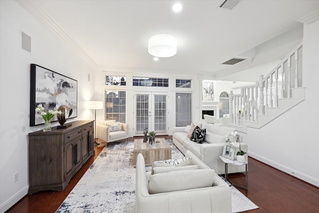 living area featuring dark wood-style floors, visible vents, crown molding, and baseboards