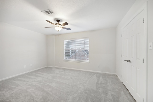 unfurnished bedroom with visible vents, baseboards, a ceiling fan, and carpet flooring