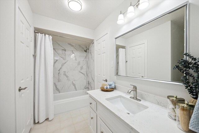 full bathroom with a textured ceiling, vanity, and shower / tub combo