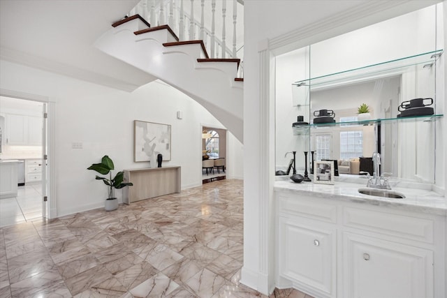 bar featuring a sink, arched walkways, marble finish floor, and a wealth of natural light