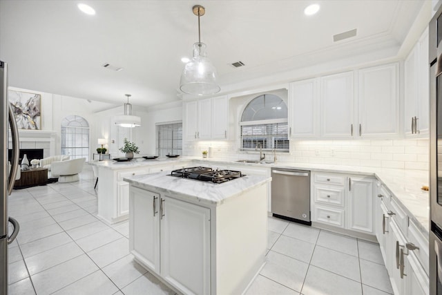 kitchen featuring visible vents, crown molding, dishwasher, a peninsula, and gas stovetop