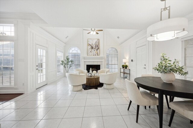 living room featuring ceiling fan, high vaulted ceiling, light tile patterned flooring, and a fireplace