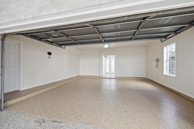 garage with french doors and baseboards