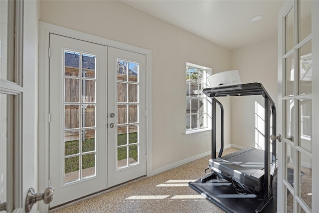 exercise area with french doors and baseboards