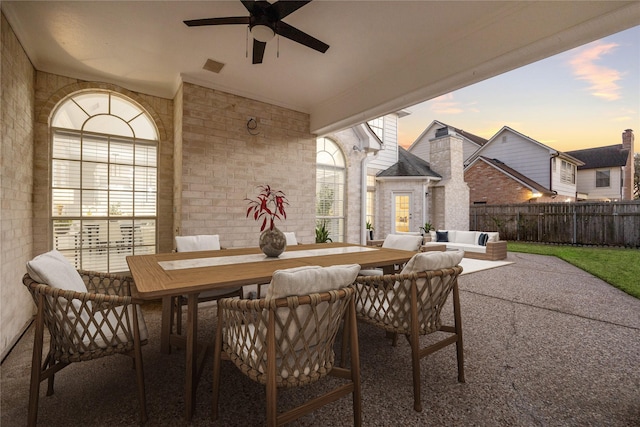 view of patio / terrace featuring outdoor dining space, a ceiling fan, fence, visible vents, and an outdoor living space