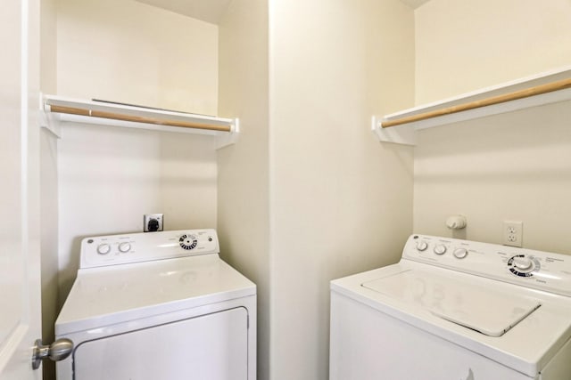 washroom featuring laundry area and washing machine and clothes dryer