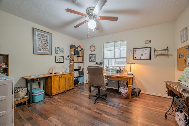 office area with baseboards, a textured ceiling, dark wood-type flooring, and ceiling fan