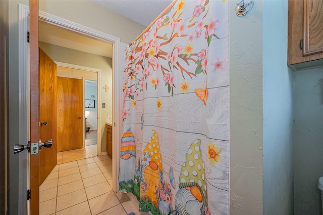 full bathroom with tile patterned floors and a shower with shower curtain