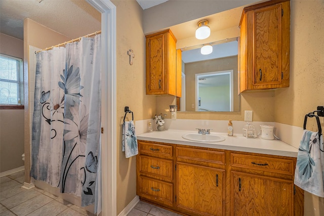 full bathroom with vanity, tile patterned floors, a shower with curtain, and baseboards