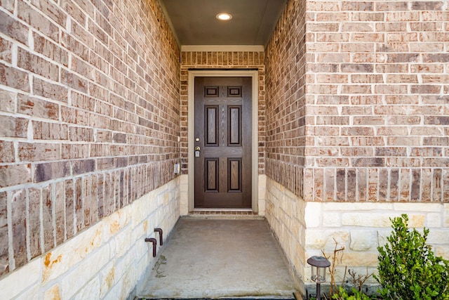 entrance to property with brick siding