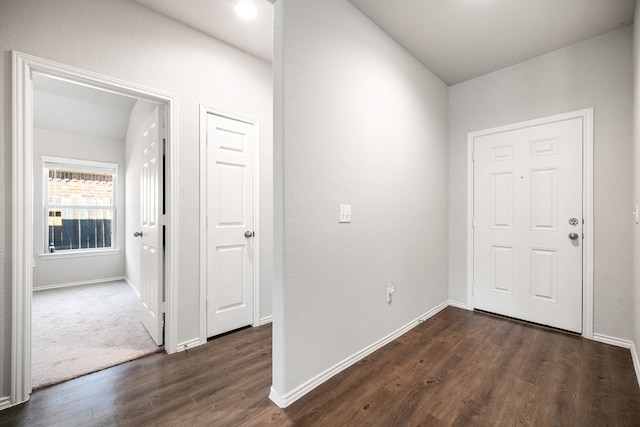 entryway featuring baseboards and dark wood finished floors