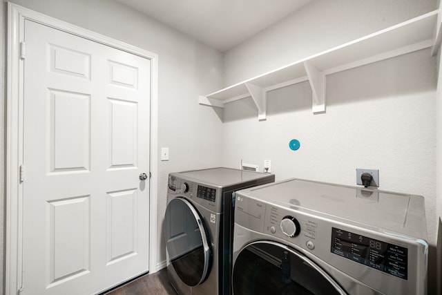 washroom with laundry area, dark wood-style floors, and washer and dryer