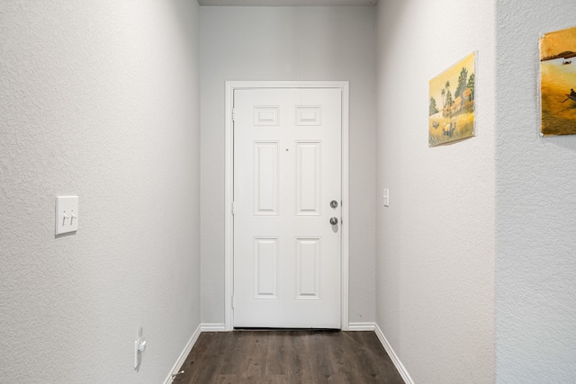 entryway featuring dark wood-style floors and baseboards