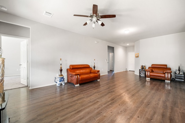 sitting room with visible vents, baseboards, and wood finished floors