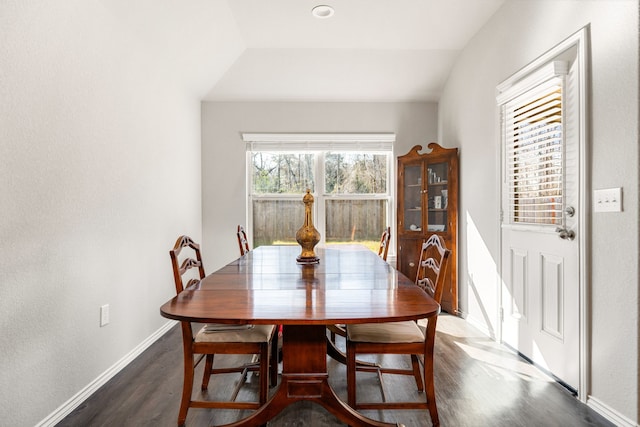 dining space featuring dark wood-style floors and baseboards