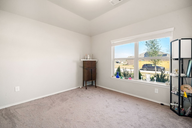 carpeted spare room with visible vents and baseboards