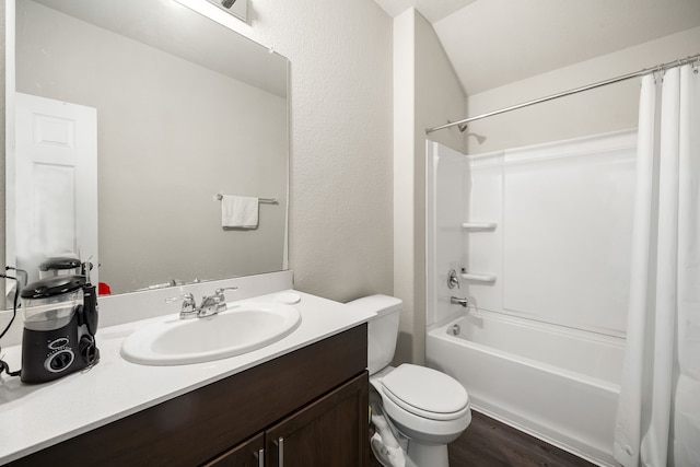 full bath featuring shower / tub combo, a textured wall, toilet, wood finished floors, and vanity