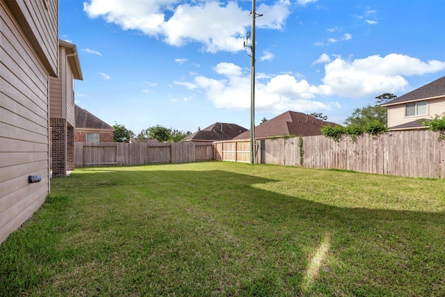 view of yard with a fenced backyard