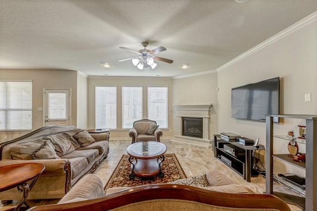 living area with baseboards, a ceiling fan, a glass covered fireplace, and ornamental molding