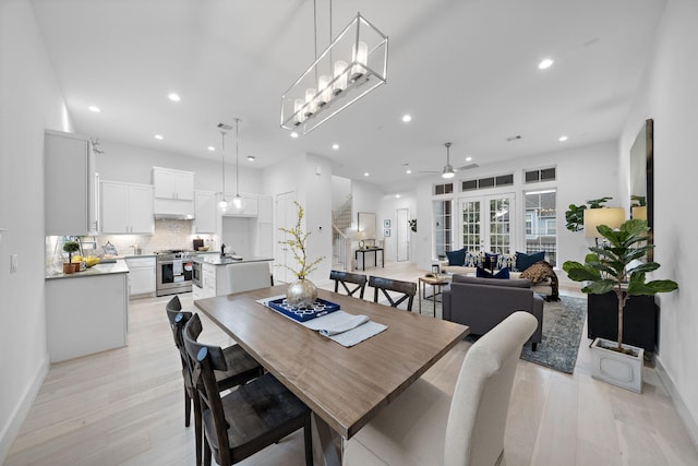 dining space featuring baseboards, a ceiling fan, light wood-style flooring, and recessed lighting