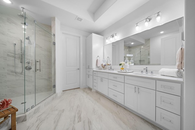 full bath with marble finish floor, visible vents, a sink, and a marble finish shower