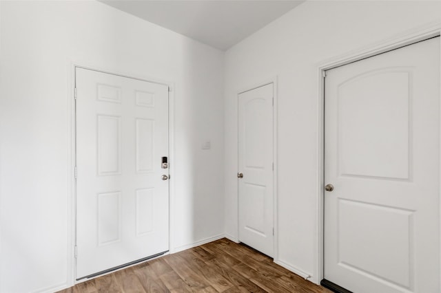 entryway featuring wood finished floors and baseboards