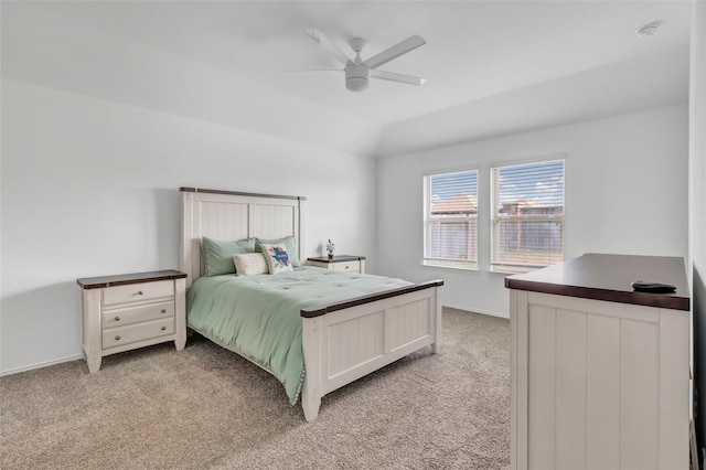 bedroom featuring baseboards, light carpet, lofted ceiling, and a ceiling fan