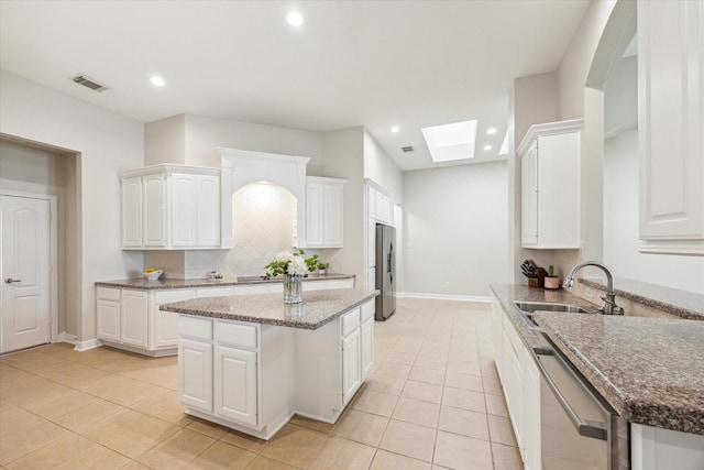 kitchen with visible vents, a skylight, recessed lighting, a sink, and appliances with stainless steel finishes