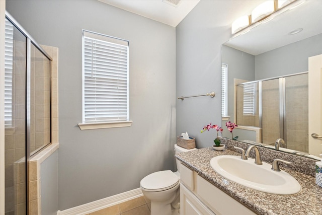 bathroom featuring toilet, tiled shower, tile patterned flooring, baseboards, and vanity