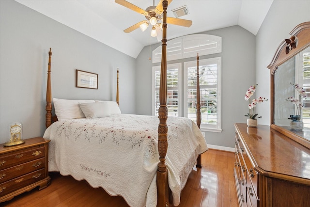 bedroom featuring visible vents, a ceiling fan, lofted ceiling, and wood-type flooring