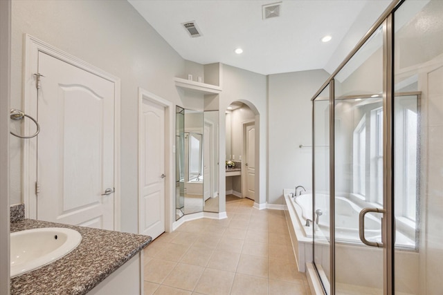 bathroom featuring vanity, tile patterned floors, a bath, and visible vents