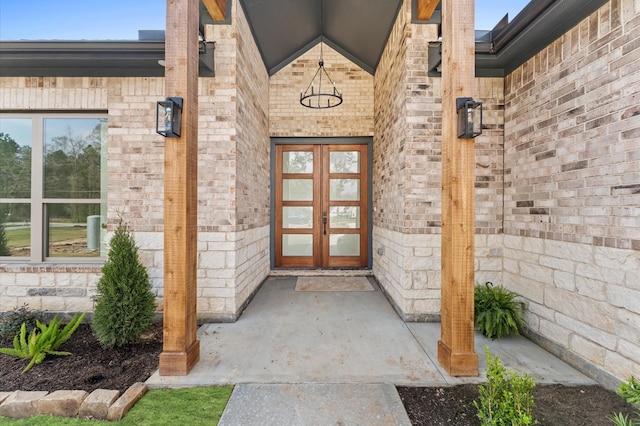 doorway to property with french doors and brick siding