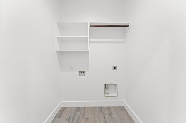 laundry room featuring hookup for a washing machine, hookup for an electric dryer, laundry area, wood finished floors, and baseboards