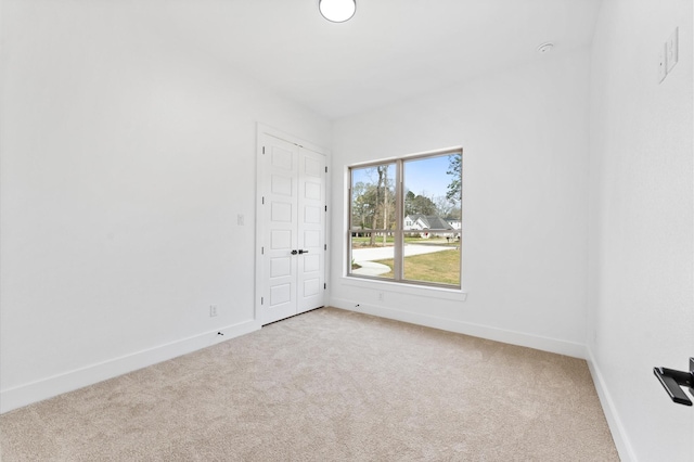 carpeted spare room with baseboards