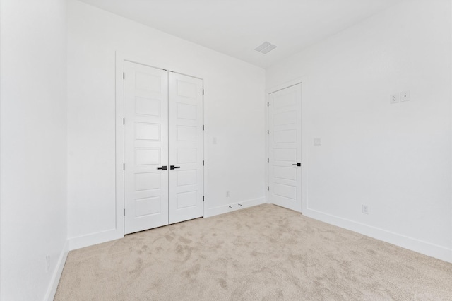 unfurnished bedroom featuring carpet floors, baseboards, and a closet