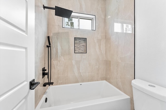 bathroom featuring tub / shower combination and toilet