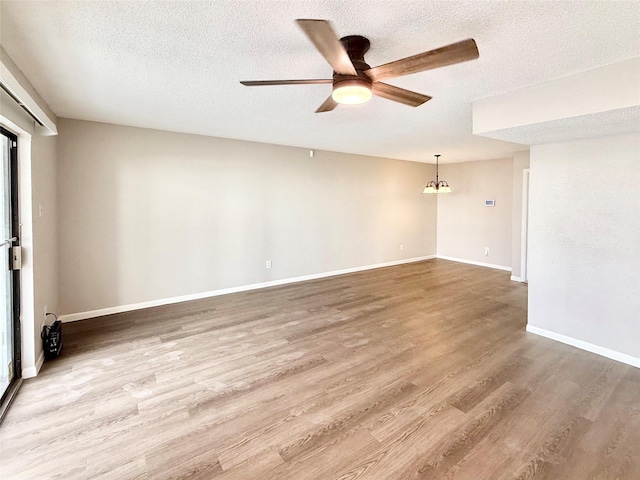 unfurnished room featuring ceiling fan, a textured ceiling, baseboards, and wood finished floors