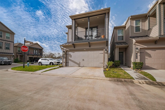 townhome / multi-family property with driveway, a balcony, and a garage