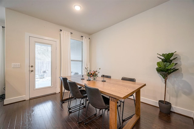 dining space featuring dark wood-style floors and baseboards