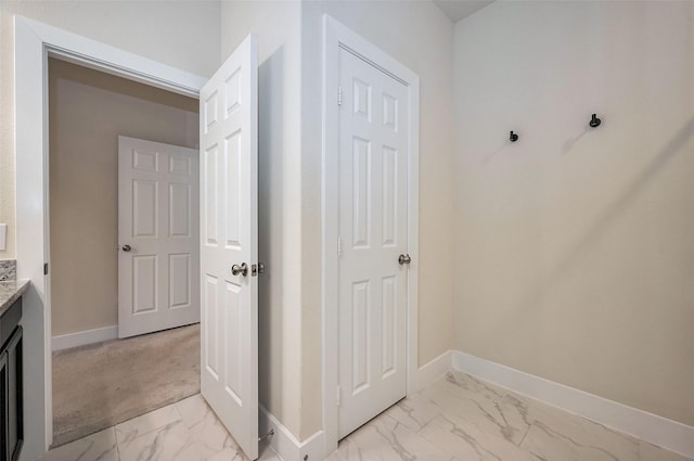 interior space with marble finish floor and baseboards