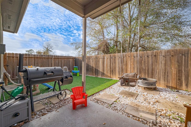 view of patio featuring a fenced backyard and a grill