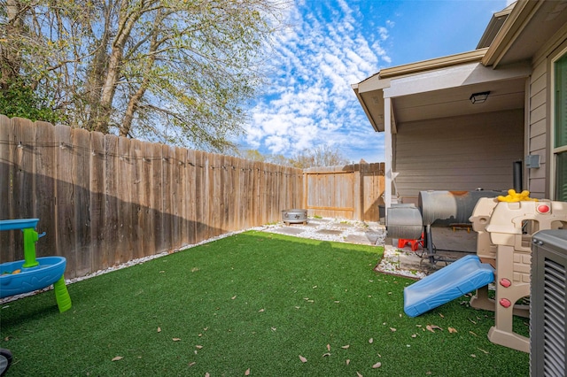 view of yard with heating fuel and a fenced backyard