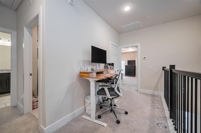 home office featuring light colored carpet, visible vents, and baseboards