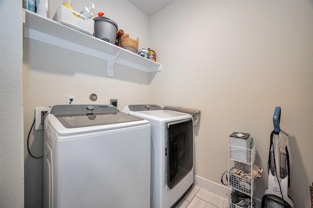 laundry room featuring laundry area, baseboards, and washer and dryer