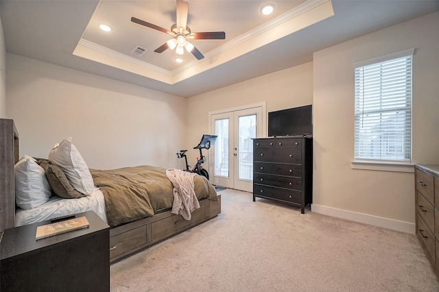 bedroom featuring light carpet, access to outside, a tray ceiling, and french doors