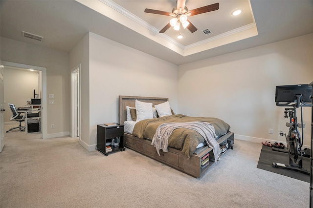 carpeted bedroom with baseboards, ornamental molding, visible vents, and a raised ceiling