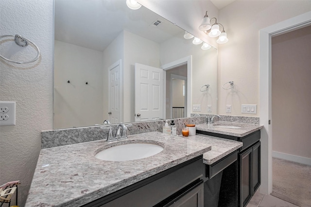 bathroom with visible vents, vanity, and baseboards