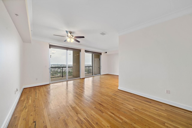 unfurnished room with light wood-type flooring, baseboards, ornamental molding, and a ceiling fan