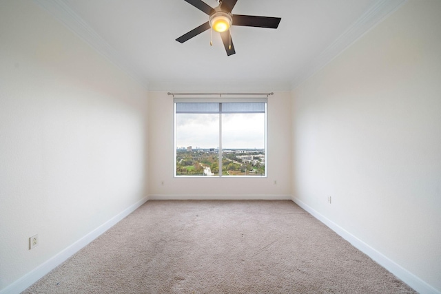 unfurnished room with ornamental molding, light colored carpet, baseboards, and a ceiling fan