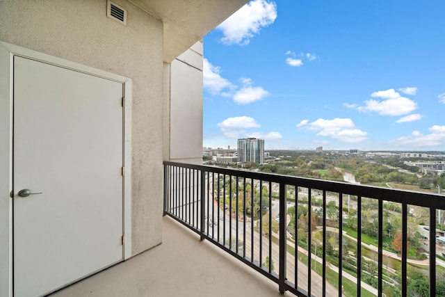 balcony with a view of city and visible vents